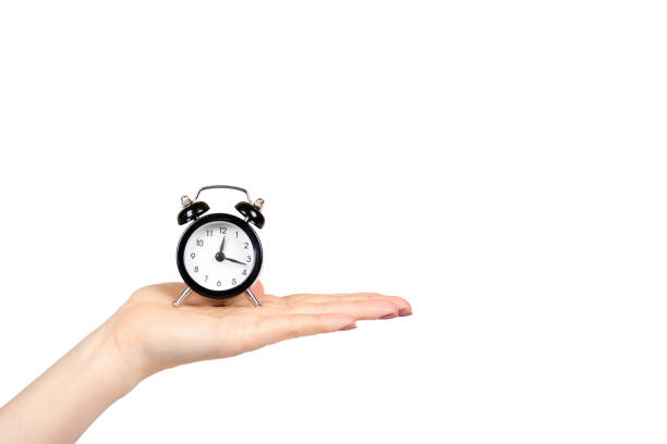 istock Hand with black retro alarm clock, classic watches with bells. 1161724417