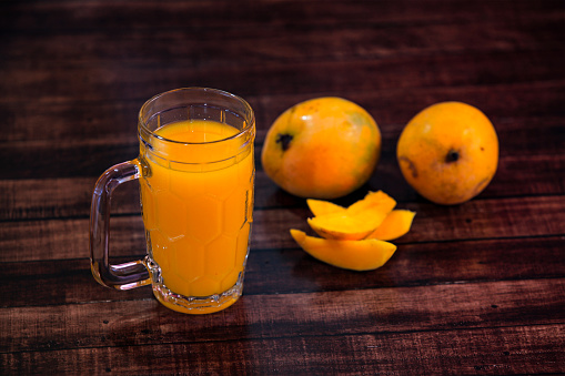 Mango Juice and mango slice in dark Background