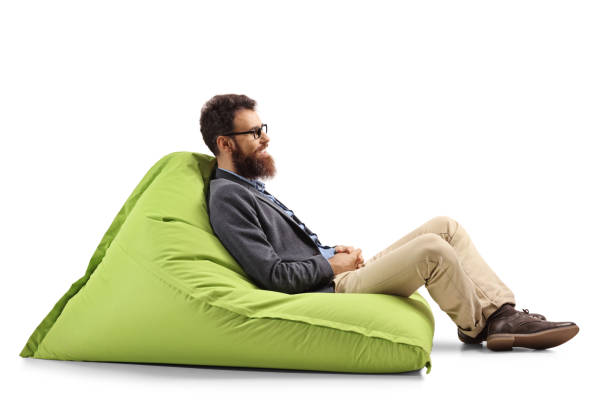 istock Bearded man sitting on a modern green bean bag chair 1161727905