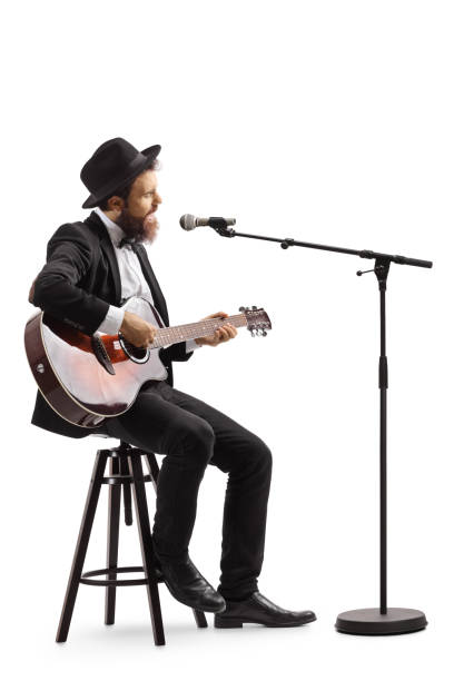 istock Guy singing on a microphone and playing an acoustic guitar 1161728102