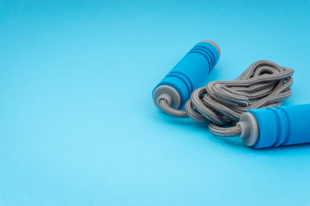 istock Skipping rope or jumping rope isolated on blue background 1161728137