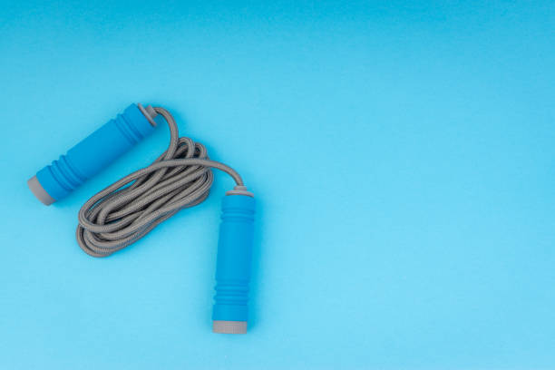 istock Skipping rope or jumping rope isolated on blue background 1161728144