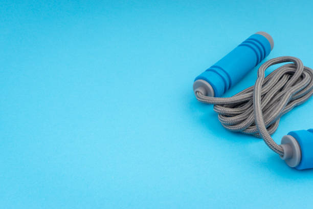 istock Skipping rope or jumping rope isolated on blue background 1161728179