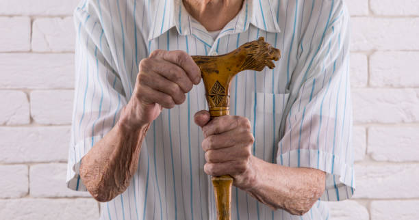 istock hands of an old man on a crutch 1161730188