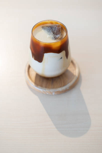 istock Ice cold caramel latte on wooden table in cafe 1161732386