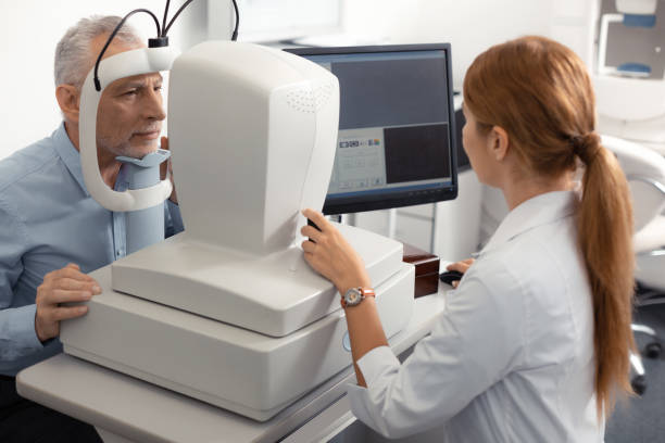 istock Ophthalmologist wearing white uniform sitting near laptop 1161733515