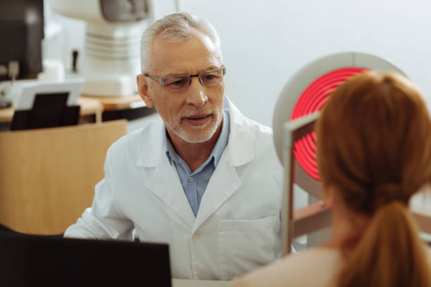 istock Professional ophthalmologist feeling busy while examining patient 1161733530