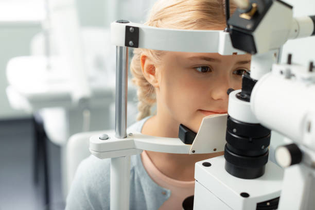 istock Girl looking into special glasses while having eye sight consultation 1161733604