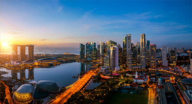 Singapore city and sunrise sky in harbour side view Singapore city and sunrise sky in harbour side view of hotel windows singapore photos stock pictures, royalty-free photos & images