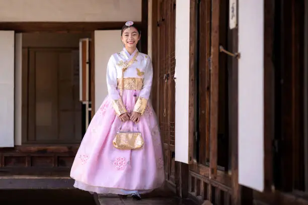 Korean lady in Hanbok or Korea gress and walk in an ancient town and Gyeongbokgung Palace in seoul, Seoul city, South Korea.