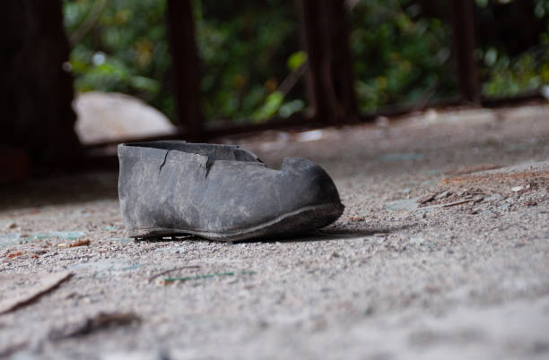 Aftermath war - single torn shoe galosh in a ruined building