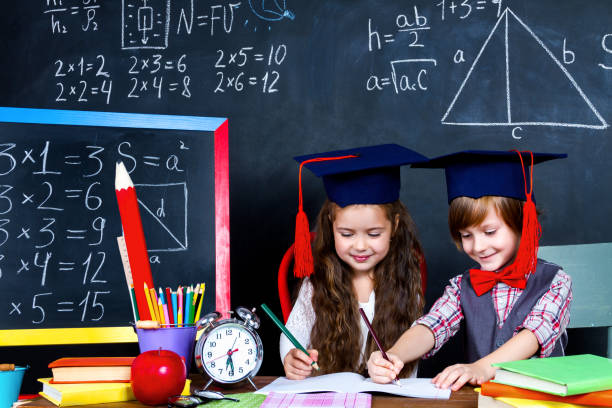 istock Schoolgirl and schoolboy in classroom at elementary school 1161734665