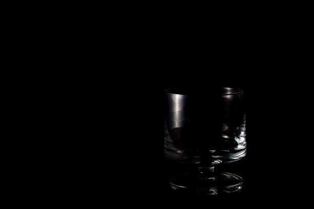 istock Closeup on isolated glass on black background 1161735380