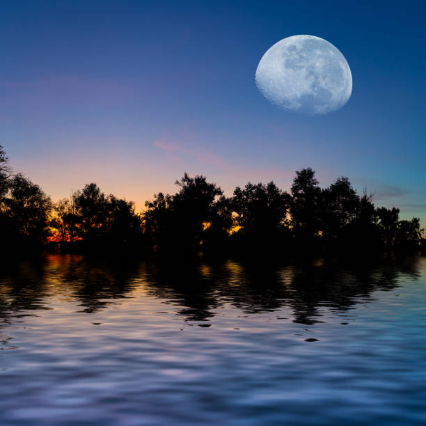 istock huge moon above the small lake at the twilight 1161736396