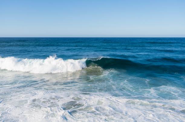 istock Blue ocean waves crash on a tetrapods breakwater 1161736571
