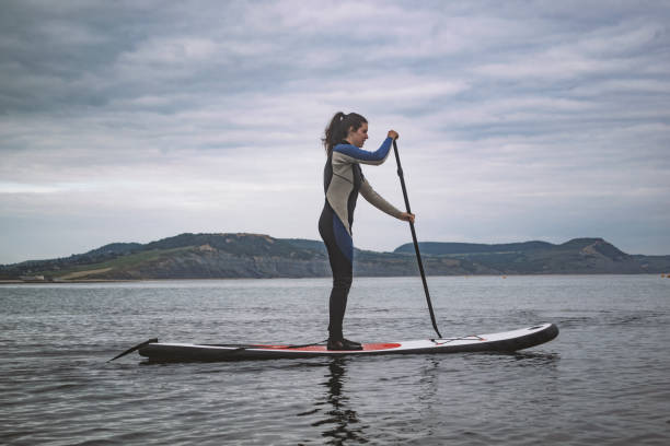 istock A woman paddle boarder on calm evening seas 1161738975