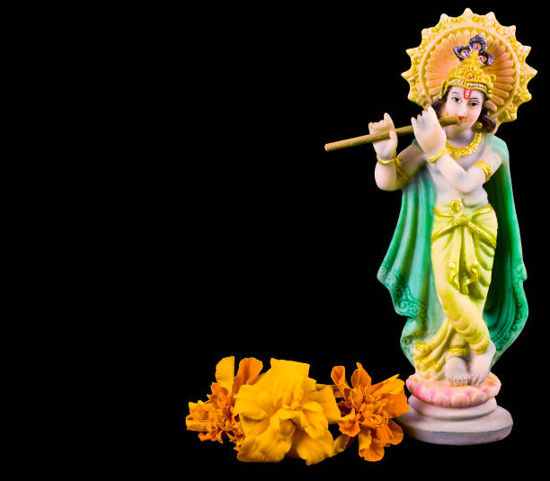 istock Hindu god Krishna. Statue with marigold flowers 1161746121