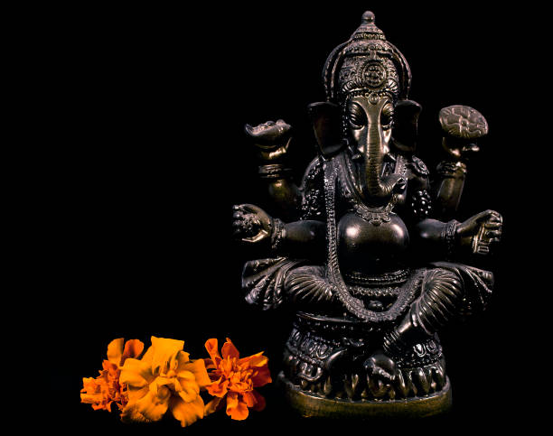 istock Hindu god Ganesha. Statue with marigold flowers 1161746128