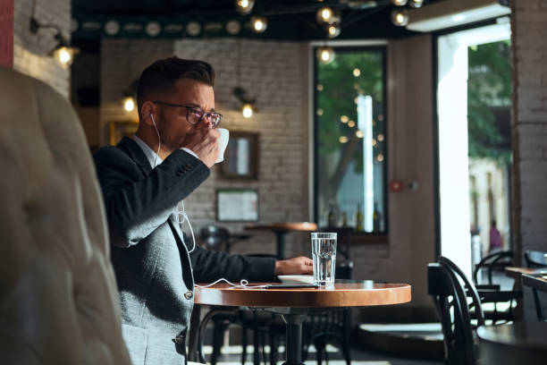 istock Happy businessman on a coffee break using phone with headphones 1161746429