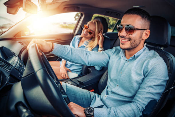 Enjoying road trip Enjoying road trip.Leisure, road trip,people and travel concept -man and woman driving in car. driver stock pictures, royalty-free photos & images