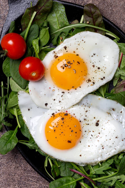istock Close up yolks of egg with salad and cherry tomatoes 1161747196