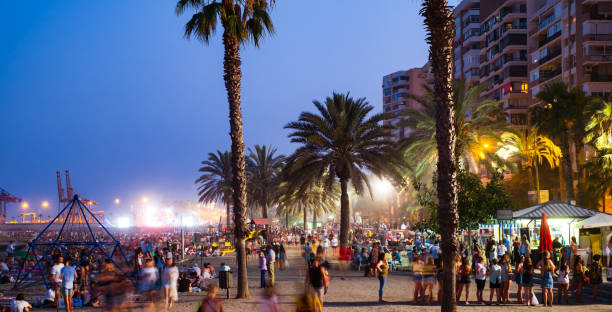 Young people celebrate the Night of San Juan with music and dance on the Malagueta beach, Malaga city, Spain Malaga, Spain - June 23, 2018. Night scene with many people at the Malagueta beach in the celebration of the night of San Juan crud stock pictures, royalty-free photos & images