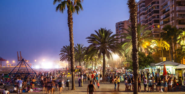 Young people celebrate the Night of San Juan with music and dance on the Malagueta beach, Malaga city, Spain Malaga, Spain - June 23, 2018. Night scene with many people at the Malagueta beach in the celebration of the night of San Juan crud stock pictures, royalty-free photos & images