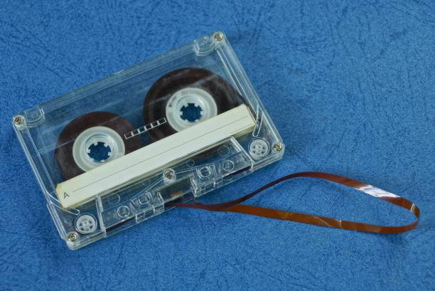 istock gray old audiotape lies on the blue board 1161748667