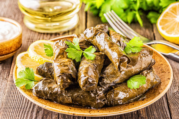 istock Dolma, stuffed grape leaves with rice and meat on dark background, selective focus 1161748744