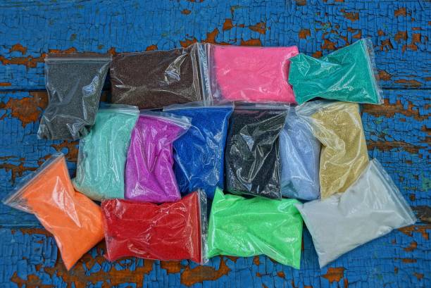 istock of plastic bags with colored sand on a blue table 1161748851