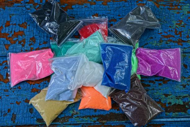 istock row of plastic bags with colored sand on a blue table 1161748970