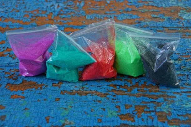 istock of plastic bags of colored sand on a blue table 1161749067