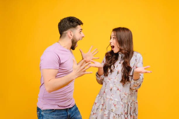 istock Young man and woman isolated over bright yellow background 1161749191