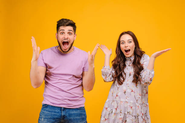 istock Young man and woman isolated over bright yellow background 1161749227