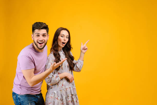 istock Young man and woman isolated over bright yellow background 1161749276