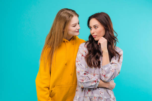 istock 2 young women isolated over turquoise background 1161749391