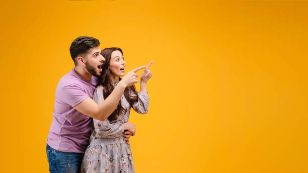istock Young man and woman isolated over bright yellow background 1161749977