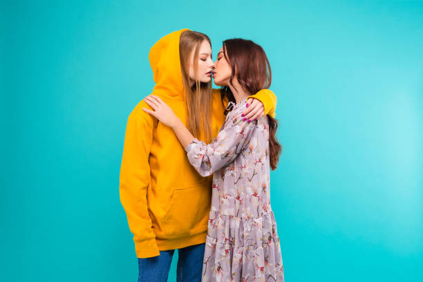 istock 2 young women isolated over turquoise background 1161750136