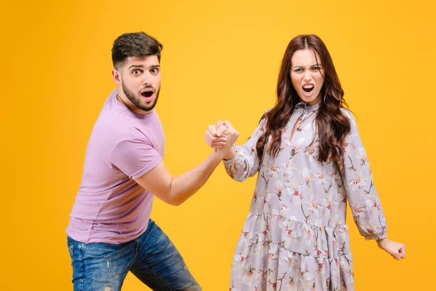 istock Young man and woman isolated over bright yellow background 1161750140