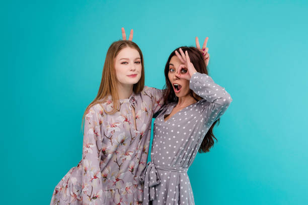istock two young women isolated over blue background 1161750212