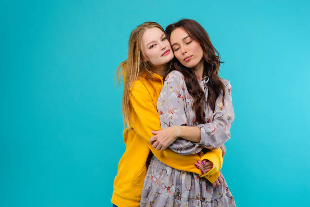 istock 2 young women isolated over turquoise background 1161750220