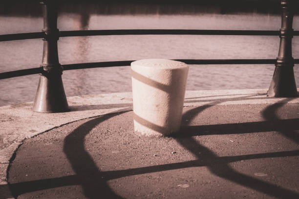 Traditional ship's mooring bollard and railing that runs along the public tow path of the River Lagan, Belfast, Northern Ireland.