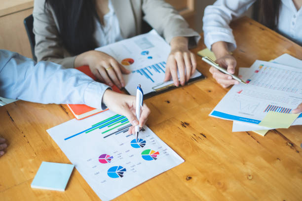 istock Young business people working together with graph documents in office space market research industry concept 1161750584