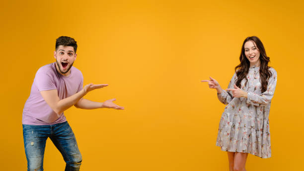 istock Young man and woman isolated over bright yellow background 1161752721