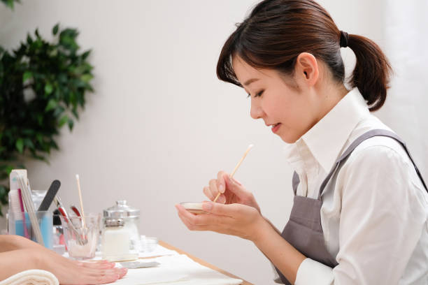 istock Nail stylist decorating customer's fingernails 1161753830