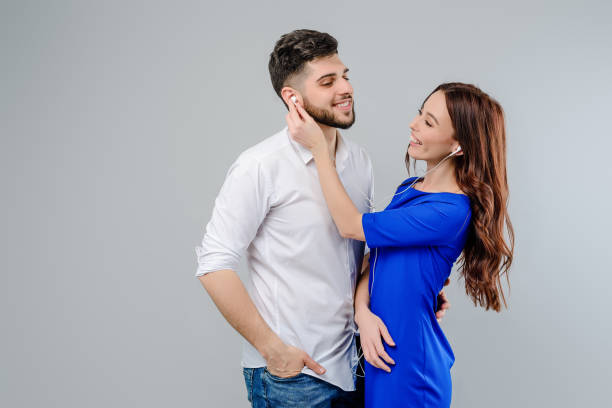 istock young man and woman isolated over gray background 1161755612