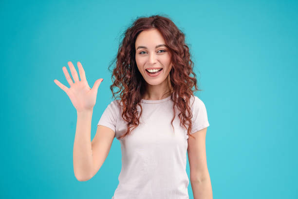 istock woman saying hello isolated 1161757924