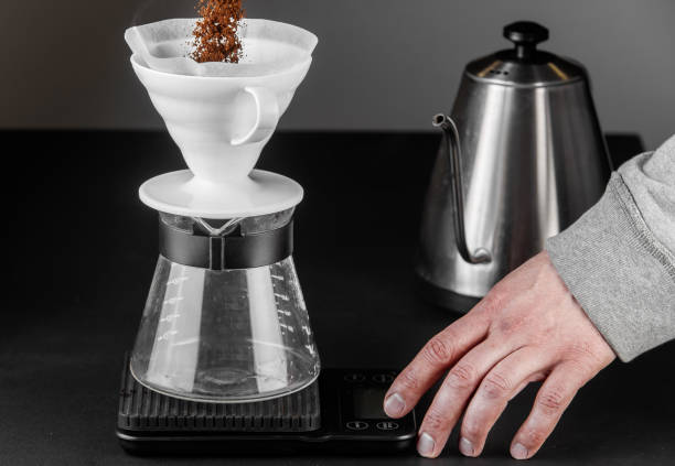 istock Alternative method of making coffee. coffeemaker is a manual pour-over style glass. Cofee brewing on black background 1161758045