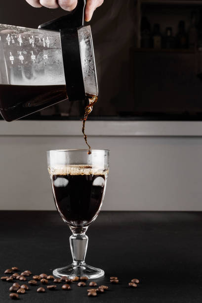 istock Alternative method of making coffee. coffeemaker is a manual pour-over style glass. Cofee brewing on black background 1161758074