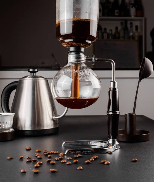 istock Siphon alternative method of making coffee. coffeemaker is a manual pour-over style glass. Cofee brewing on black background 1161758184